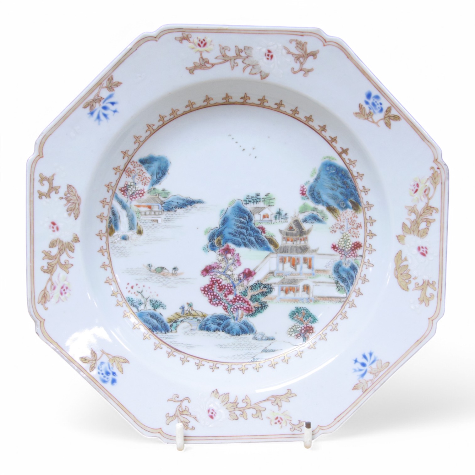 An 18th century Chinese famille rose 'landscape' octagonal plate, 22cm wide. Condition - good, minor chipping